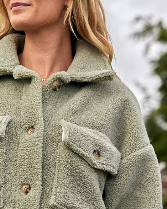A woman wearing a Laurie - Womens Sherpa Fleece Coat - Green Saltrock jacket.