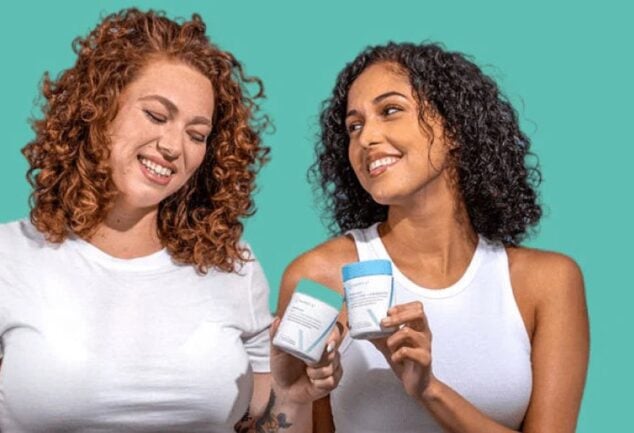 Two women holding Happy V wellness products in a bright lifestyle scene