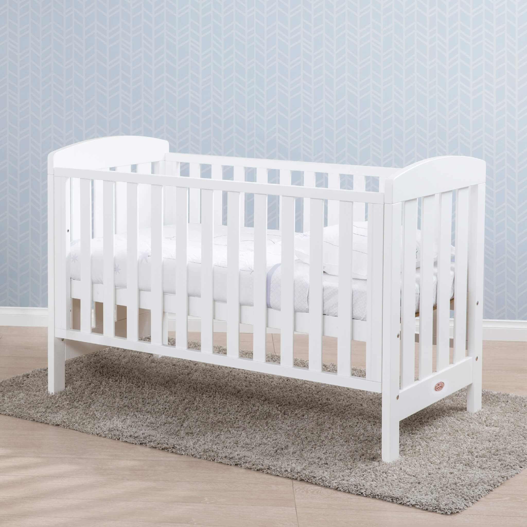 Alice cot bed showing its curved timber frame