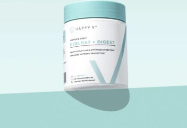 Happy V Debloat + Digest supplement bottle on a colored background