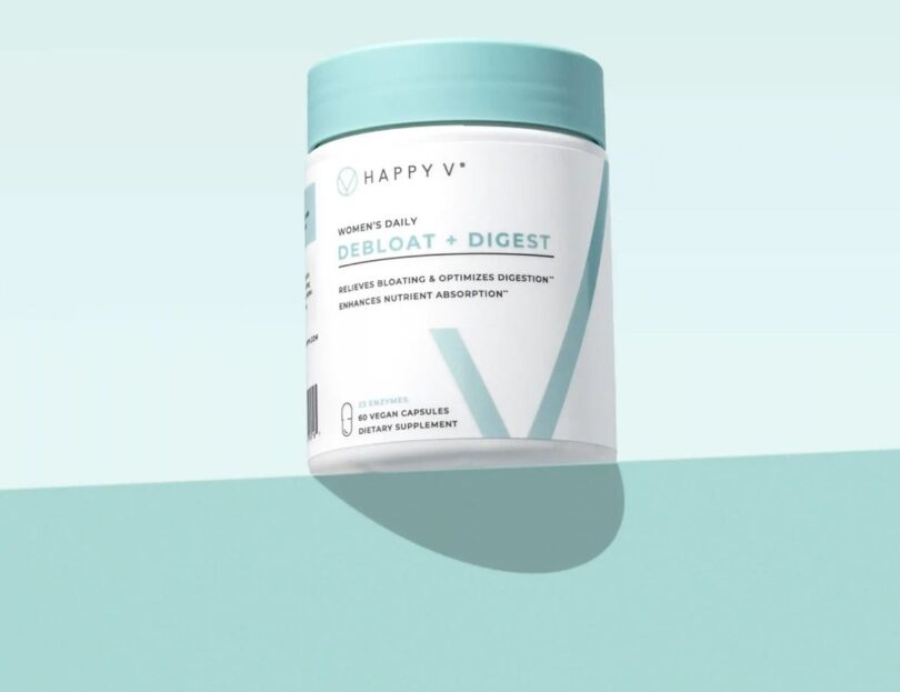 Happy V Debloat + Digest supplement bottle on a colored background