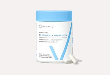 Happy V Prebiotic and Probiotic supplement bottle on a gray background