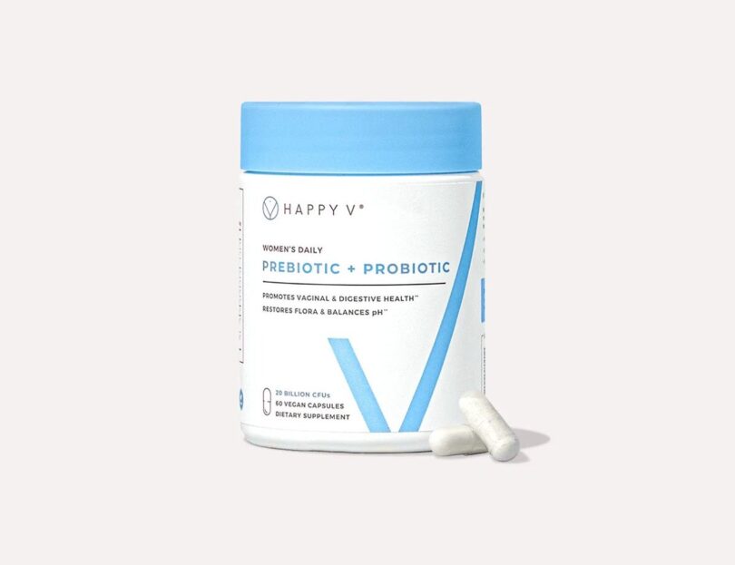 Happy V Prebiotic and Probiotic supplement bottle on a gray background
