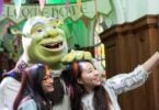 Visitors posing with Shrek at Shrek's Adventure in London