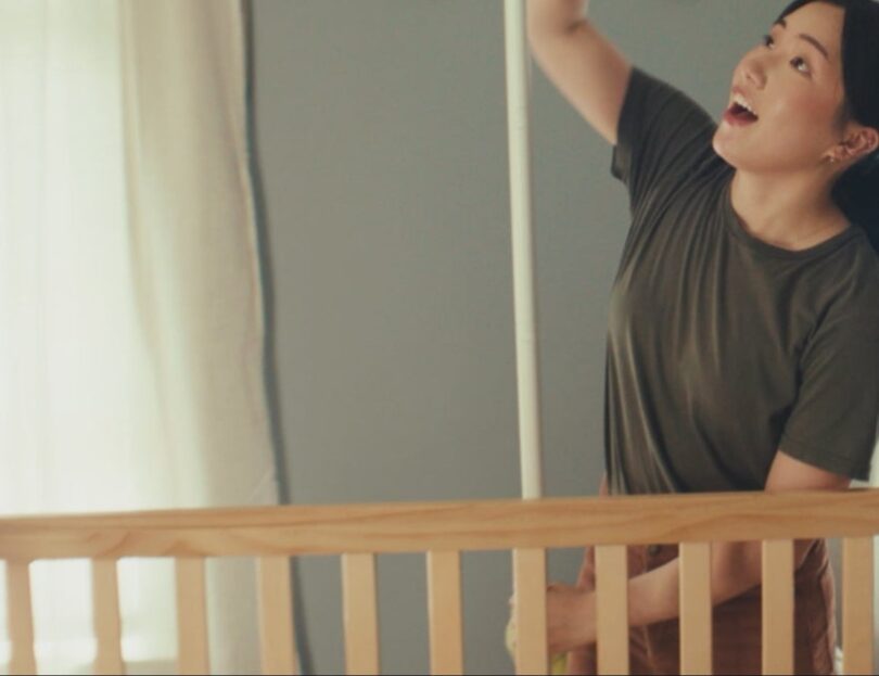 Nanit baby monitor in a nursery scene