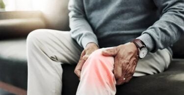 Person holding glowing knee