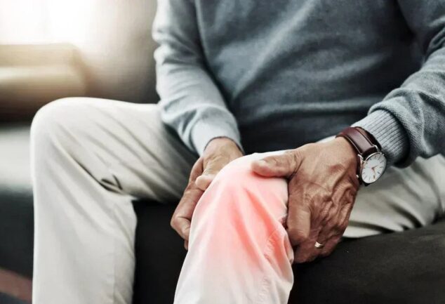 Person holding glowing knee