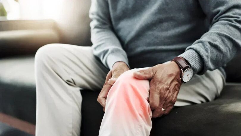 Person holding glowing knee