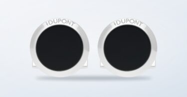 ST Dupont round black lacquer cufflinks on a light background