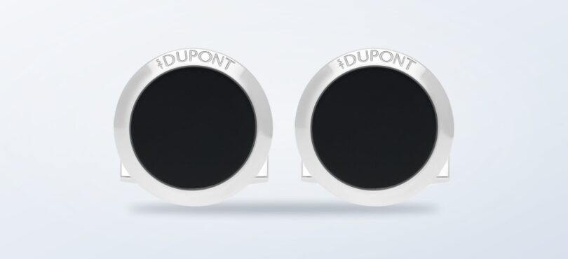 ST Dupont round black lacquer cufflinks on a light background
