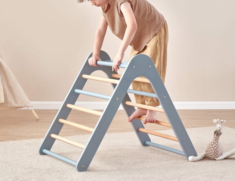 Child climbing a Boori Tidy Climbing Triangle in a playroom