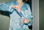 Person pouring an Astro Dust drink into a glass mug