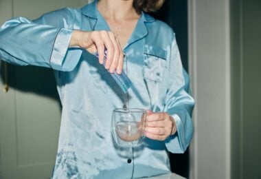 Person pouring an Astro Dust drink into a glass mug